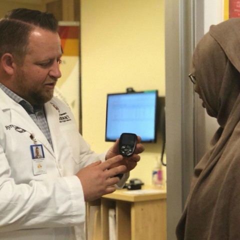 Director of Pharmacy Byron Jones, Pharm.D., discusses the importance of testing blood sugar regularly with a La Maestra patient. (Photo by Jennifer Cao, Pharm.D.)