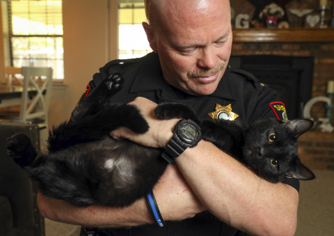 With the help of nearly 4,000 animal welfare partners, PetSmart and PetSmart Charities today announced they reached the milestone of 8 million pet adoptions since 1994. Zeus, a playful black cat and the lucky 8 millionth pet, was adopted by Heath Greenlee, a deputy sheriff for the Tarrant County Sheriff's Office in Texas, through PetSmart Charities' in-store adoption program at the Hulen PetSmart in Fort Worth. PetSmart and PetSmart Charities hope to find homes for thousands of pets in need during its National Adoption Weekend events held at nearly all PetSmart stores across North America this weekend from May 18-20. (Photo: Business Wire)