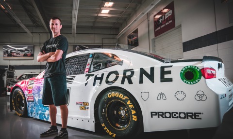 Champion Leavine Family Racing Driver Kasey Kahne stands in front of the newly wrapped Thorne-sponsored car. (Photo: Business Wire)