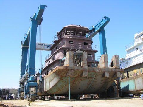A steel tug sits on the 660-ton Travelift at Metal Shark’s newly-acquired Alabama Shipyard, formerly ... 