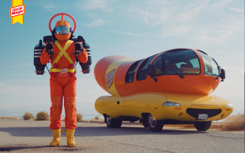 Super Hotdogger stands next to the vehicle that first ignited the brand’s mission of delivering a better Oscar Mayer Hot Dog, the Wienermobile. (Photo: Business Wire)