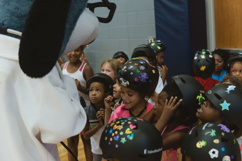 Boys & Girls Club members greet UnitedHealthcare mascot Dr. Health E. Hound as part of a fun-filled ... 