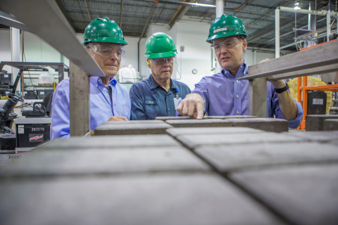 Solidia Technologies® CTO Nick DeCristofaro (left) and CEO Tom Schuler (right) inspect Solidia Concrete™ CO2-cured pavers. (Photo credit: Marc Morrison)