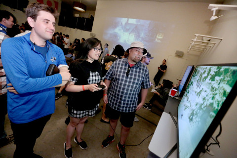 In this photo provided by Nintendo of America, fans play Octopath Traveler on the Nintendo Switch at the iam8bit Gallery Octopath Traveler launch celebration in Los Angeles. Octopath Traveler is now available in Nintendo eShop on Nintendo Switch and is available at retailers on July 13. 