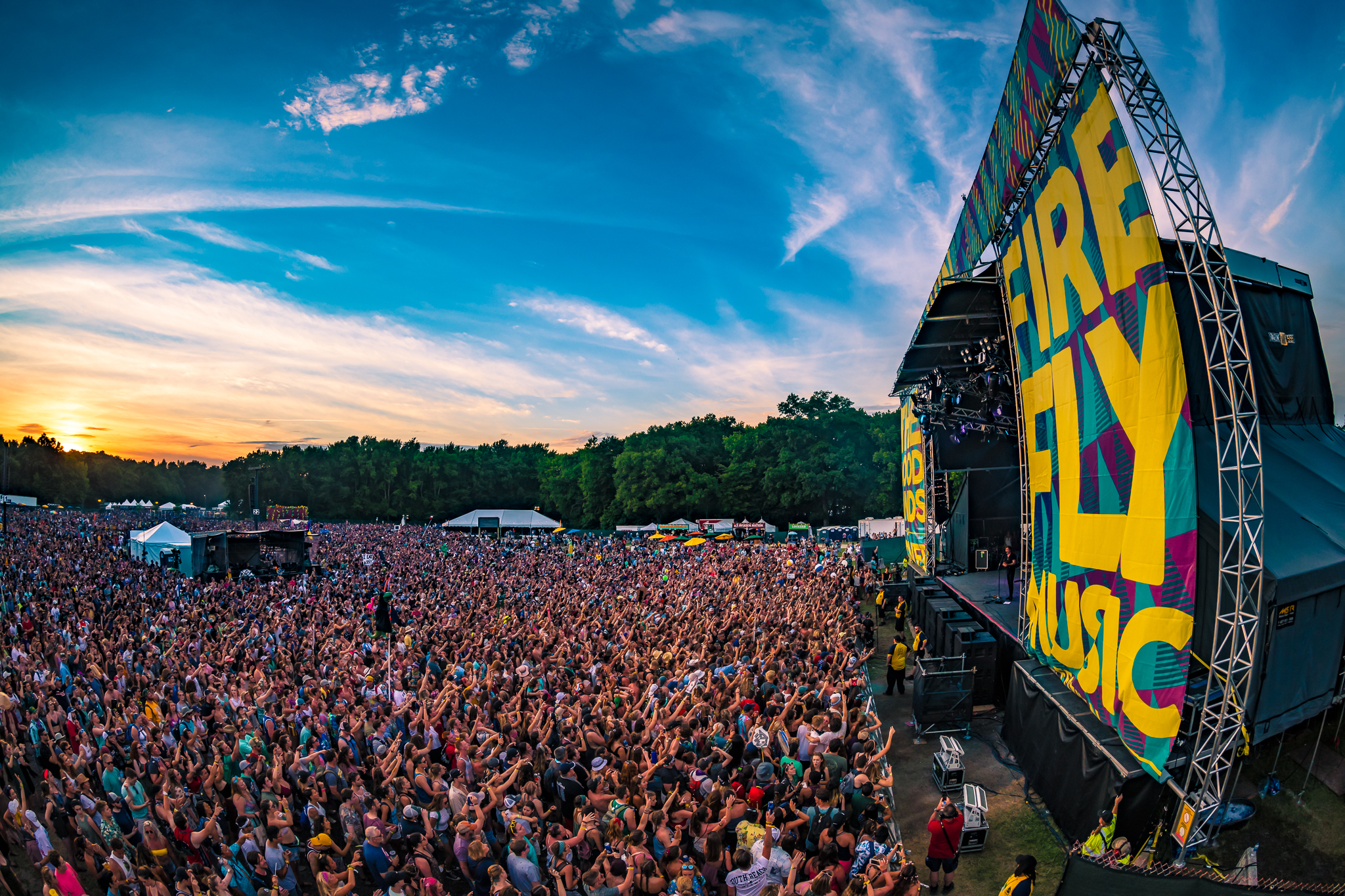 A packed audience faces a large stage at The Firefly Music Festival.