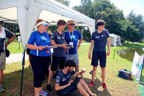 A RoboBoat team watches progress from the shoreline. (Photo: Business Wire)