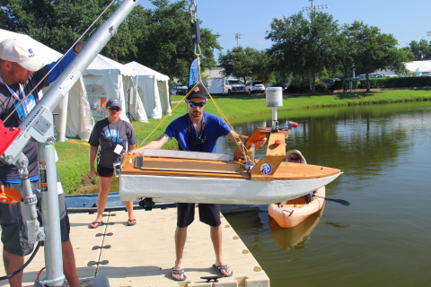 A crane is used to hoist the AV boats into the water. (Photo: Business Wire)