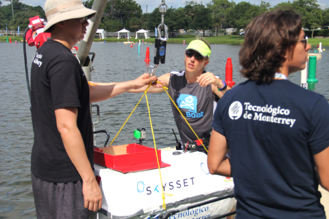 Teams prepare to hoist their vehicle into the water. (Photo: Business Wire)