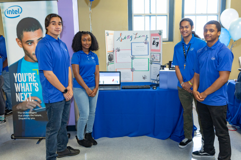 Intel interns (from left) Jonathan Cortez, Redeat Kibebew, Andy Kim and Angelo Edgerly pose with their project Sing Lang, a sign language translator. On completion of their six-week paid internships, 37 interns from Oakland Technical and McClymonds high schools presented projects, many incorporating Intel Corporation technology, to their families, schools and communities during a presentation in Oakland, Calif., on Thursday, July 26, 2018. (Credit: Intel Corporation)