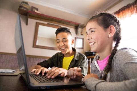 Two kids using Comcast’s Internet Essentials program to connect to the Internet. Internet Essentials is the largest and most-comprehensive broadband adoption for low-income Americans. (Photo: Comcast)