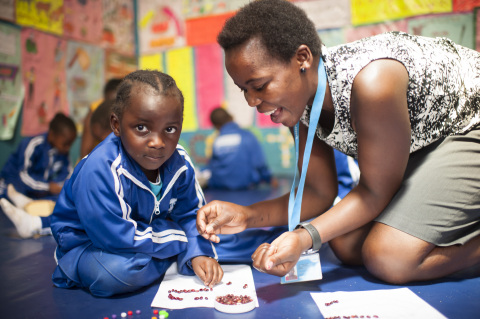 SHOFCO ECD teacher Lilian A.  Owino  working with Edel Rose Amanya on a session of art. Photo courtesy of Joop Rubens/SHOFCO.
