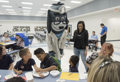 UnitedHealthcare mascot Dr. Health E. Hound greets kids from the Alhambra School District as they get ready to receive a no-cost comprehensive eye exam as part of a back-to-school eye-health event at the Alhambra Family Resource Center using the Eye Care 4 Kids mobile clinic. The event is part of a nationwide grant program by UnitedHealthcare. Eye Care 4 Kids in Arizona received a $5,000 grant for the local event (Photo: Mark Peterman).