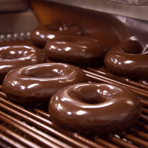 Krispy Kreme Doughnuts is bringing back its wildly popular Chocolate Glazed Doughnut on the first Friday of every month beginning Friday, Sept. 7, at participating Krispy Kreme shops across the United States and Canada. (Photo: Business Wire)