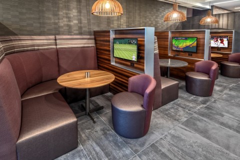 Personal television screens provide privacy in the lobby's booths. (Photo: Business Wire)