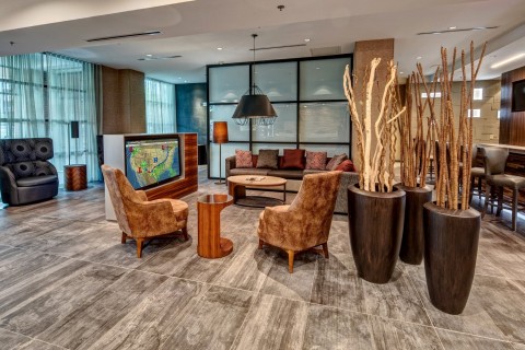 The warm, modern lobby is a natural place to watch the news. (Photo: Business Wire)