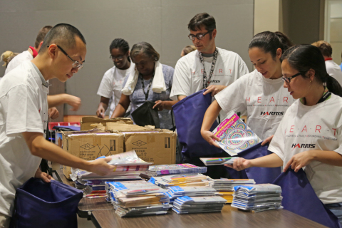 Harris Corporation employees in Palm Bay, Florida, assemble care packs as part of a company-sponsored service event to support local community needs. (Photo: Business Wire)