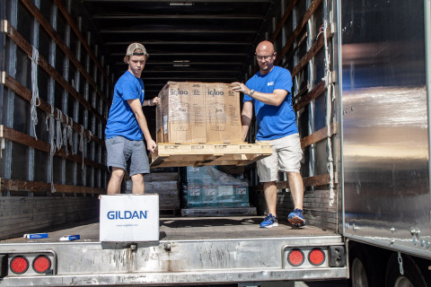 PGT Innovations' team members unloading supplies. (Photo: Business Wire)