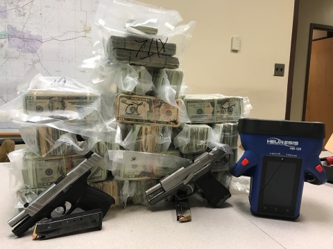 US Currency and Weapons Seizure (Photo: Business Wire)