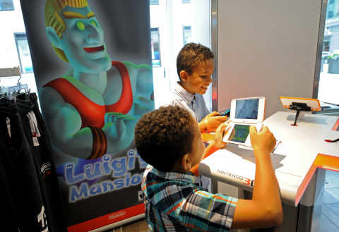 In this photo provided by Nintendo of America, Joshua A., 9 and Jacob A., 6, of Brooklyn, NY, help Luigi in his spooky adventure by playing the Luigi’s Mansion on the New Nintendo 2DS XL during a special event at the Nintendo NY store in Rockefeller Plaza. The classic game Luigi’s Mansion will be available for the Nintendo 3DS family of systems on Oct. 12. (Photo: Business Wire)