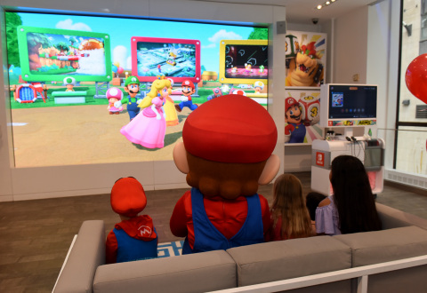 In this photo provided by Nintendo of America, guests celebrate the launch of the Super Mario Party game by challenging Mario during a special event at the Nintendo NY store in Rockefeller Plaza. An action-packed party game with 80 interactive mini-games, Super Mario Party is now available for the Nintendo Switch system. (Photo: Business Wire)