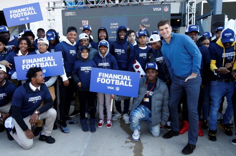 NFL players Saquon Barkley (front, fifth from the left) and Eli Manning (front, second from the right) partner with Visa to launch Financial Football video game. The free video game lets fans ages 11 and older suit up as a player from their favorite NFL team and play a virtual game of football designed to help students learn to make smart money-management decisions. (Photo: Business Wire)
