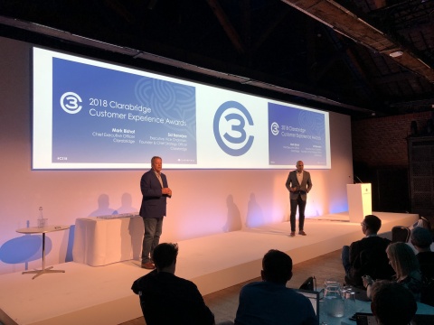 Clarabridge CEO Mark Bishof (left) and Managing Director of Clarabridge EMEA Jagrit Malhotra (right) greet the audience at C3 London. (Photo: Business Wire)