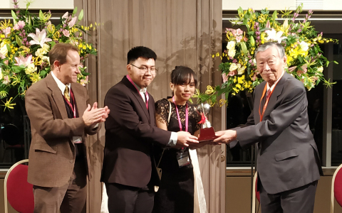 Dr. Masahiro Katoh (Chairman, Edogawa Hospitals) awarding the Fujio Cup to Mr Tommy and Ms Grace (Bandung Institute of Technology, Indonesia), in the presence of Dr Ian Gallicano (George Town University). (Photo: Business Wire)