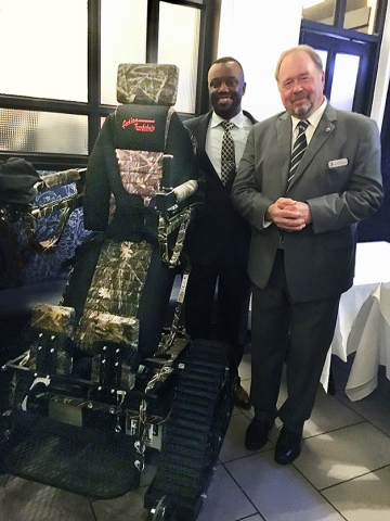 Dave Mann, Senior Vice President of Operations at NTS, donates the TrackStander to Willie Jordan, the Charitable Organizations Program Manager for the Wounded Warrior Regiment. (Photo: Business Wire)