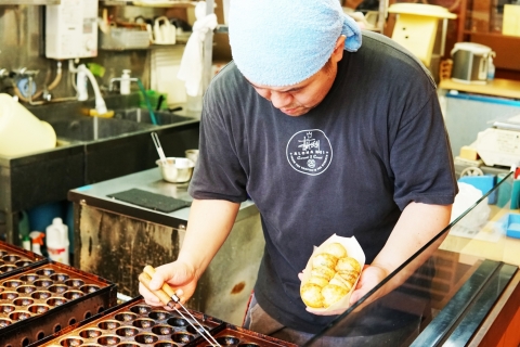 Takoyaki stalls serving freshly grilled octopus dumplings, the popular street food in Osaka. (Photo: Business Wire)