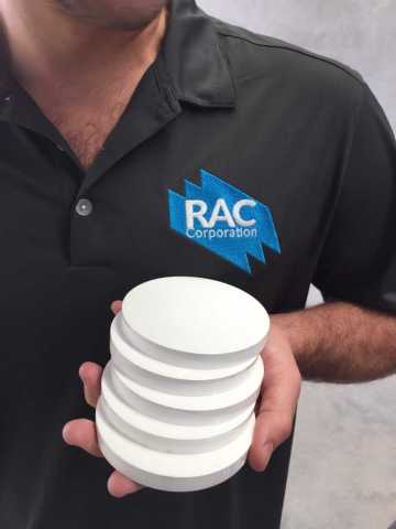 RAC's VP of Business Development, Macrae Carden, holding newly pressed Zirconia Disks. (Photo: Busin ... 