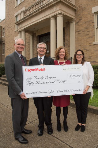 Exxon Mobil Corporation Chairman and Chief Executive Officer Darren Woods presents the company’s annual holiday gift of $50,000 to Family Compass, a nonprofit organization dedicated to ending child abuse and neglect through in-home mentoring and life-altering community educational programs. From left to right: Darren Woods, Randy Michero, founding board member of Family Compass, Ona Foster, Family Compass Chief Executive Officer, and Kathy Woods.