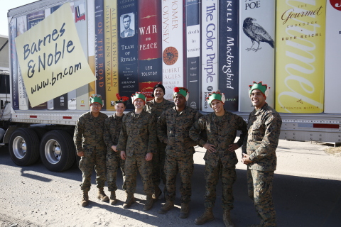 A group of Marines unload a truck full of books, toys, games, puzzles, and collectibles donated by B ... 