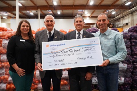 Exchange Bank President and CEO Gary Hartwick and Bill Schrader, Exchange Bank Chairman of the Board, present a $20,000 check to Redwood Empire Food Bank CEO David Goodman and Director of Development, Lisa Cannon. (Photo: Business Wire)