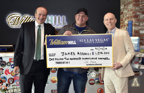 (L-R): William Hill US CEO Joe Asher, James Adducci and SLS Las Vegas general manager Paul Hobson stand with an ceremonial check of Adducci's winnings after cashing his winning ticket at the William Hill Sports Book at SLS Las Vegas Hotel on April 15, 2019 in Las Vegas, Nevada. (Photo: Business Wire)