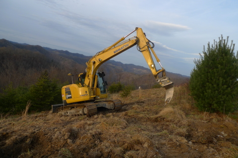 A Komatsu hydraulic excavator helps prepare a site for planting as part of Green Forests Work refore ... 