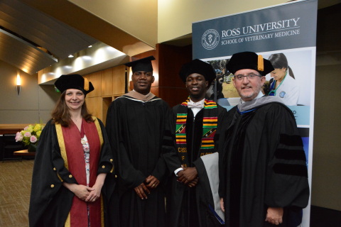 Keynote speaker Dr. Amanda Boag, St. Kitts and Nevis Deputy Prime Minister The Honourable Shawn Richards, graduate Elroy Williams and Ross University School of Veterinary Medicine Dean Sean Callanan pose for a photo before the 2019 Commencement Ceremony. (Photo: Business Wire)
