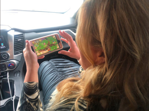 Trisha Yearwood plays FarmVille on her mobile phone while driving to the CMT Awards (Photo: Business Wire)