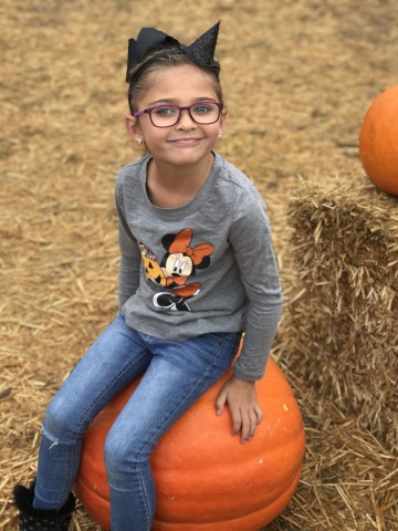 Monroe Le, 6, of San Diego, relaxes on a pumpkin about one month after gene replacement surgery to restore vision. The surgery was performed by a team from The Vision Center at Children's Hospital Los Angeles. Please credit Children's Hospital Los Angeles.