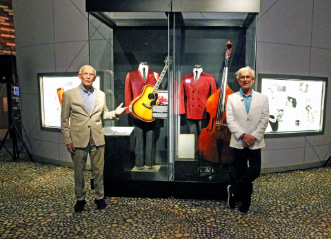 Tom and Dick Smothers stand next to the new Smothers Brothers exhibit at The National Comedy Center in Jamestown, N.Y. on July 29, 2019. (Photo: Business Wire)