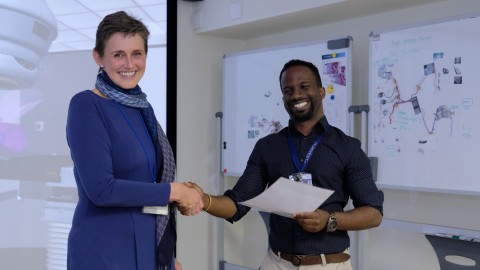 Dr. Jeannette Parkes, Head of the division of Clinical and Radiation Oncology at Groote Schuur Hospital and the University of Cape Town delivers Global Access to Cancer Care Training Completion Certificate to Kuhn Pemberton.