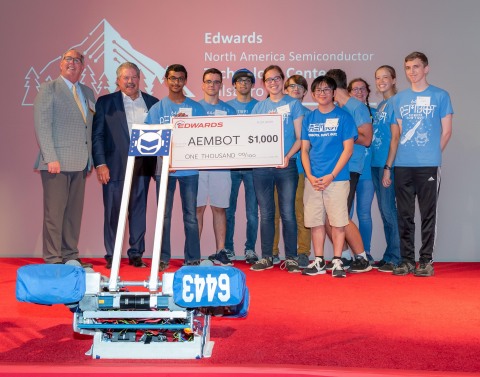 Hillsboro Mayor, Steve Callaway, and Edwards Vacuum U.S. President, Scott Balaguer, present check to AEMBOT robotics team (Liberty High School) during Edwards opening event. (Photo: Business Wire)