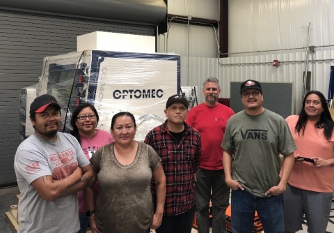 NTU students receive the Optomec LENS MTS 500 HY CA system (Pictured from left to right: Aaron Sansosie, Adriane Tenequer, Lisa Willis, Chad Yazzie, Scott Halliday, Joshua Toddy and Les Notah). Photo courtesy of NTU and Optomec.