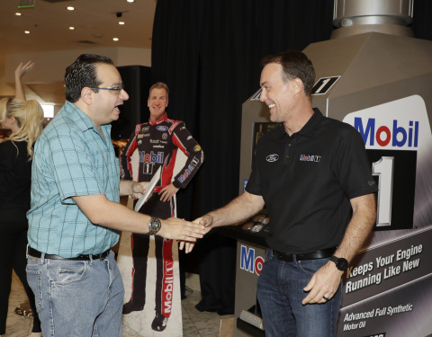 NASCAR driver Kevin Harvick at the Mobil 1™ 250K Mile Slot Machine, where fans had the chance to trade up from conventional motor oil to Mobil 1™ synthetic motor oil. (Photo: Business Wire)
