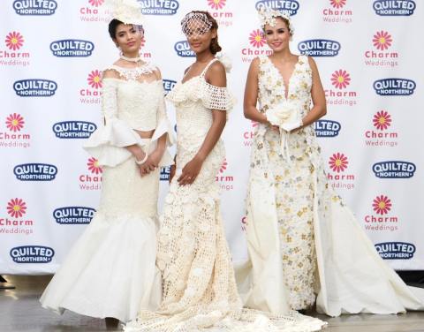 A Design by Mimoza Haska from Surfside Beach, SC (Center) is crowned the winner of the 15th Annual Toilet Paper Wedding Dress Contest presented by Charm Weddings and Quilted Northern in New York City. The runway show finale event, broadcast on national television on Monday, September 30th, revealed the $10,000 contest winner and featured the top 12 designs from more than 1500 entries crafted out of nothing more than Quilted Northern bath tissue and tape, glue or needle and thread to create intricate wedding gowns and accessories. (Photo by Charm Weddings/Quilted Northern®)