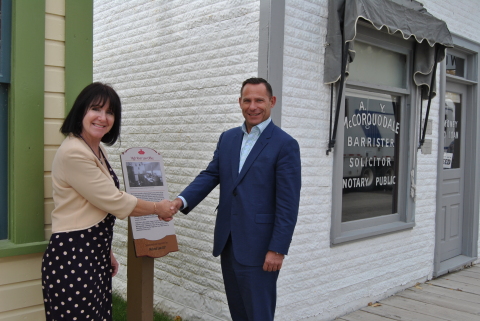 Laurene Mitchell of Heritage Park and Robin Lokhorst, Managing Partner of McLeod Law shake hands in front of the High River Law Office. (Photo: Business Wire)