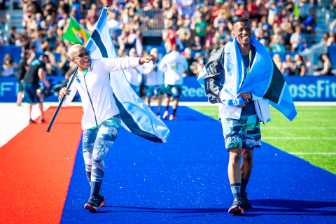 2019 Botswana National Champions Cingiwe Ciegy and Katlego Kgwadi wave to the crowd during this year's CrossFit Games. (Photo: Michael Valentin / Business Wire)