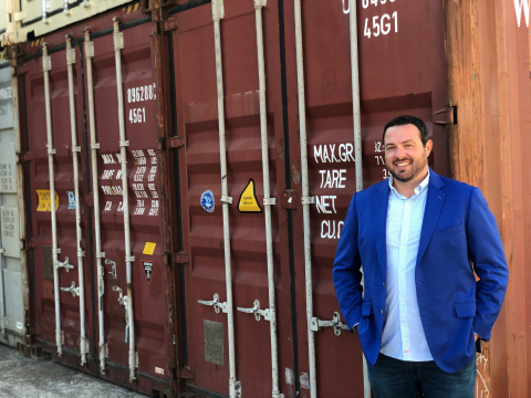 Railbox Consulting company president Mike Norton stands in front of shipping containers. (Photo: Business Wire)