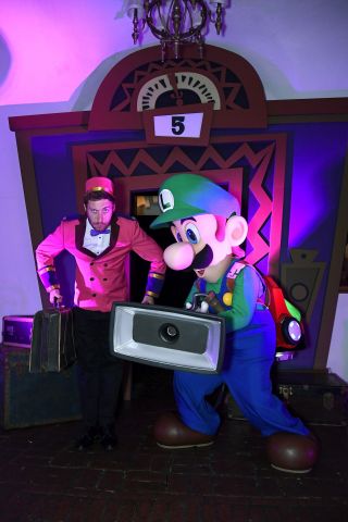 In this photo provided by Nintendo of America, Luigi from the Luigi’s Mansion 3 game poses with his handy Poltergust G-00 at a preview event in Los Angeles on Oct. 18. Luigi’s Mansion 3 is the latest game in the Luigi’s Mansion franchise, with Luigi returning as the reluctant and cowardly hero, tasked with saving his friends from a spooky hotel. The game launches exclusively for the Nintendo Switch system on Oct. 31.