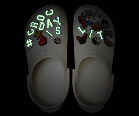 This year's limited edition #CrocDay Classic Clog will come fully loaded with a curated assortment of custom #CROCDAYISLIT Jibbitz™ charms — some of which glow! (Photo: Business Wire)