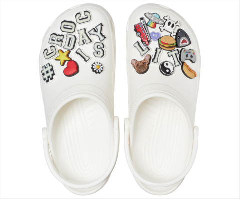 This year's limited edition #CrocDay Classic Clog will come fully loaded with a curated assortment of custom #CROCDAYISLIT Jibbitz™ charms — some of which glow! ​(Photo: Business Wire)